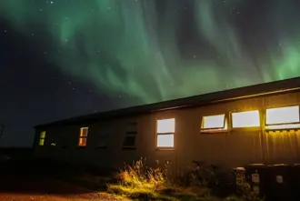Norther Lights Green Over House Iceland.
