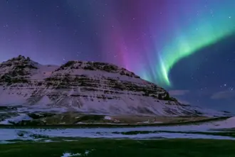 Pink Colorful Aurora Over White Mountains Iceland.