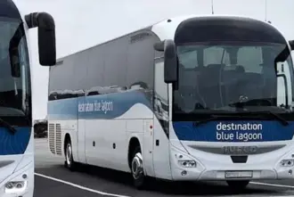  Two Destination Blue Lagoon Buses Parked in a parking lot.