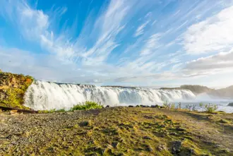 Faxi Waterfall under a blue sky.