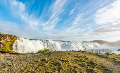 Faxi Waterfall under a blue sky.