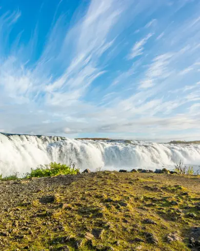 Faxi Waterfall under a blue sky.