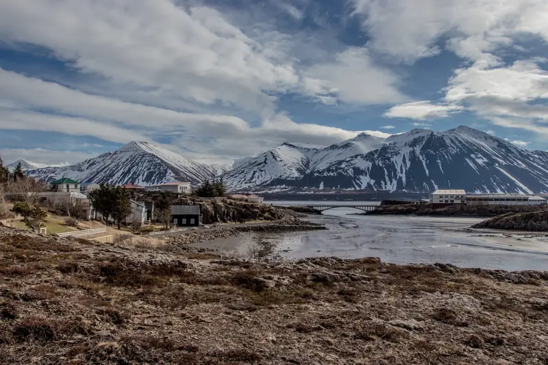 Borgarnes town with snow-capped mountains in the background, a picturesque coastal view highlighting Iceland's natural beauty.