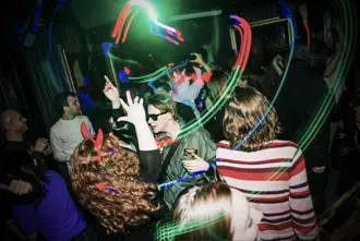 Kiki Gay Bar in Reykjavik, filled with neon lights and lively guests, showcasing the bar's colorful nightlife vibe.