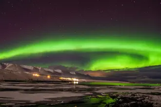 Akureyri Iceland Northern Lights green over fjord. 