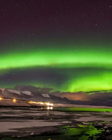 Akureyri Iceland Northern Lights green over fjord. 