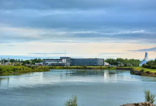 Exterior of Hotel Selfoss with riverside view.