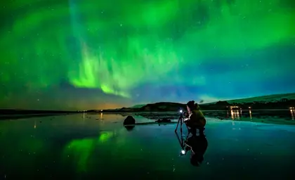 Person in front of a geyser during sunset on a private golden circle tour in Iceland.