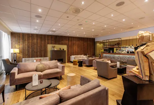 Akureyri Berjaya Iceland Hotels lobby with seating areas and a bar. 