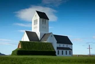 Skálholt Church, a historical landmark in Iceland under a bright blue sky
