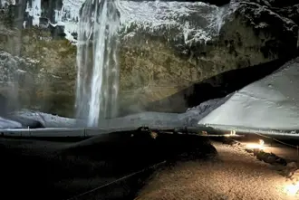 Seljalandsfoss In Winter Surrounded By Snow And Lit Up In The Darkness Medium