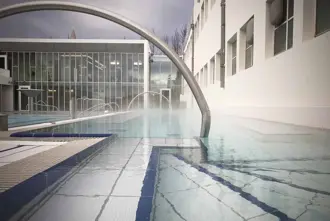 Sundholl reykjavikur swimming pool hot tub area with handrail.