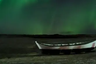 Aurora Borealis in Iceland over a Boat.