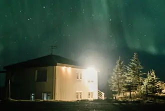 House Under Fading Northern Lights Iceland.
