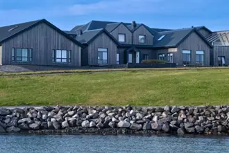 Hotel Berg Keflavik Iceland with ocean in front of the hotel building.