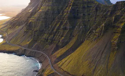 Aerial view of the towering Súlur mountains near Breiðdalsvík, Iceland, during a ring road self drive tour around Iceland.