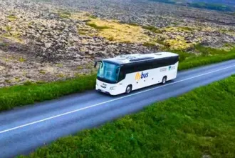 Flybus airport shuttle bus diving through a lava field.