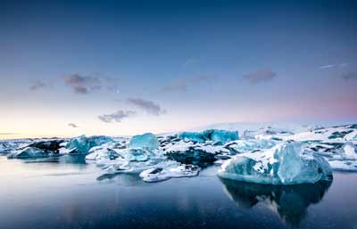 Icebergs floating in the serene waters of Jökulsárlón glacial lagoon in Iceland.