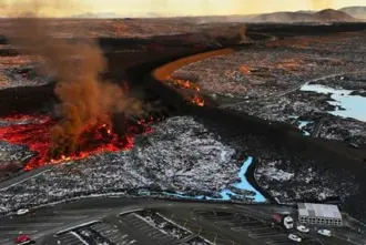 Aerial view of the Blue Lagoons protective barriers with hot lava flowing outside the barriers.