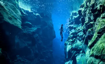 Underwater view of diver in Silfra at Þingvellir National Park in Iceland.