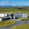 Aerial view of Landhotel, a modern, white building surrounded by Iceland’s lush green countryside with distant mountains in the background.