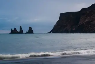 Reynisdrangar view from Vikurfjara black sand beach in Iceland.