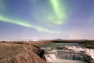 Aegissidurfoss Waterfall At Hella Iceland Under Northern Lights.