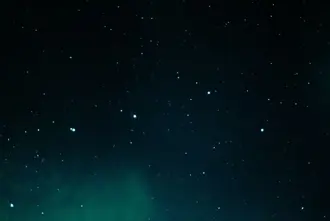 Faded Norther Lights In Dark Night Sky Over Diamond Beach Iceland.