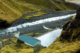 Seljavallalaug Hot Spring surrounded by moss covered cliffs, located between Kefavik and Vik South Iceland.