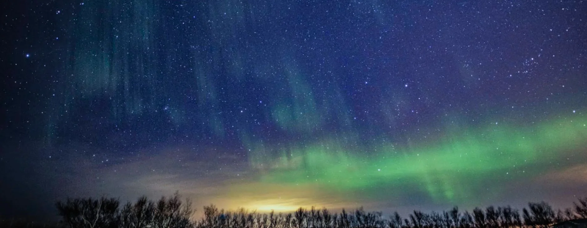Northern Lights And Starry Sky Over Hella In Iceland.