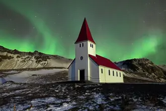 Northern Lights In Vik Iceland Vikurkirkja Church Under Aurora.