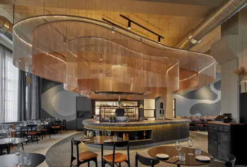 Mýrín Restaurant at Grandi Center Hotels, displaying a sophisticated setup with dark furniture, artistic light fixtures, and an inviting dining space.